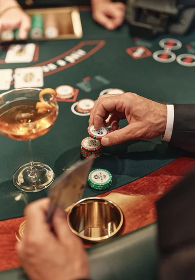 A hand placing chips beside the cards on the ante line