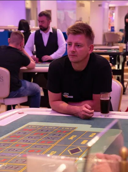 A guest at the roulette table, watching the layout