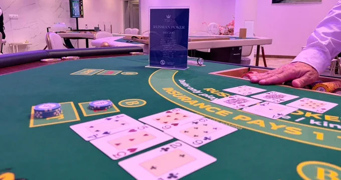 A Russian Poker table, a five-card hand spread face up beside the ante and bet boxes
