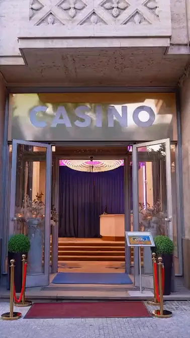 A dealer spreading the deck across the poker table